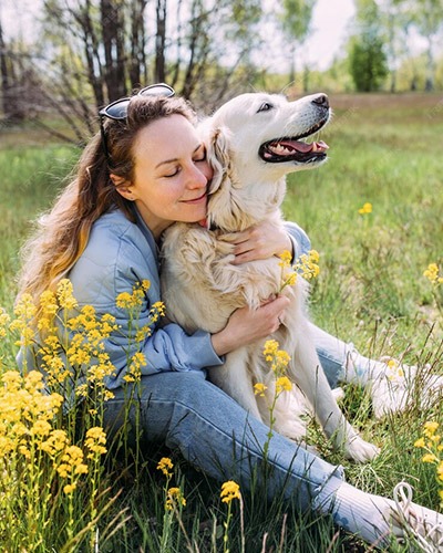 Dog being hugged by its owner after veterinary care in Mesa, AZ